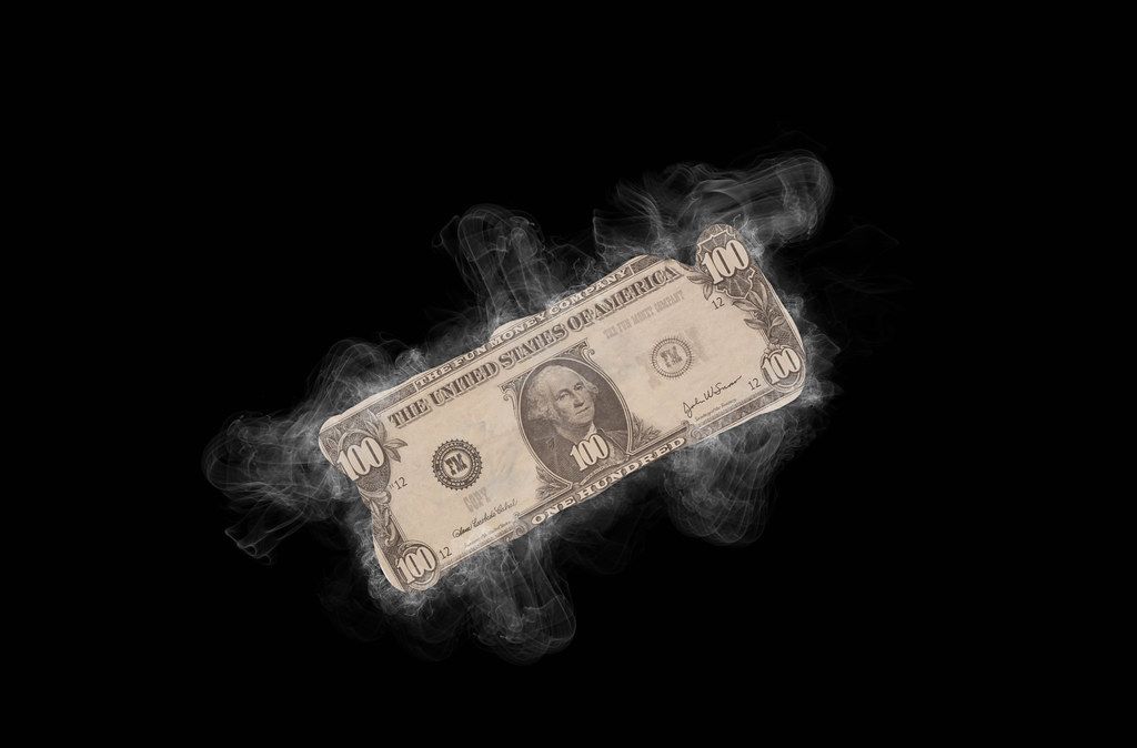 Dollar banknote with smoke on black background