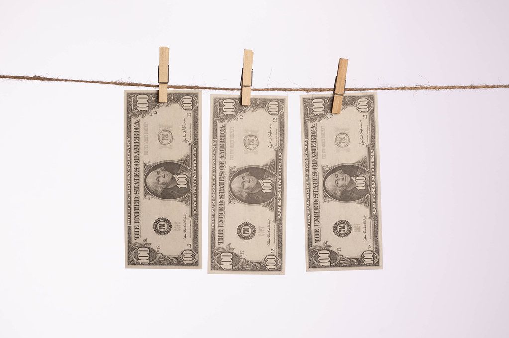 Dollar bills hanging on a clothes line
