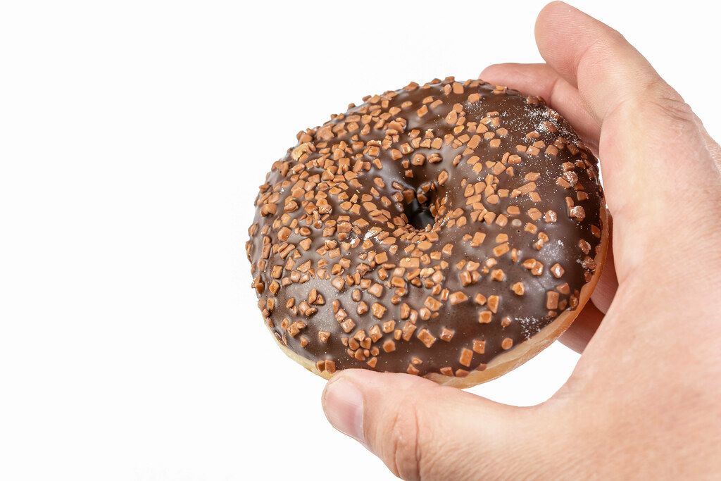 Donut with Chocolate Topping in the hand (Flip 2019)