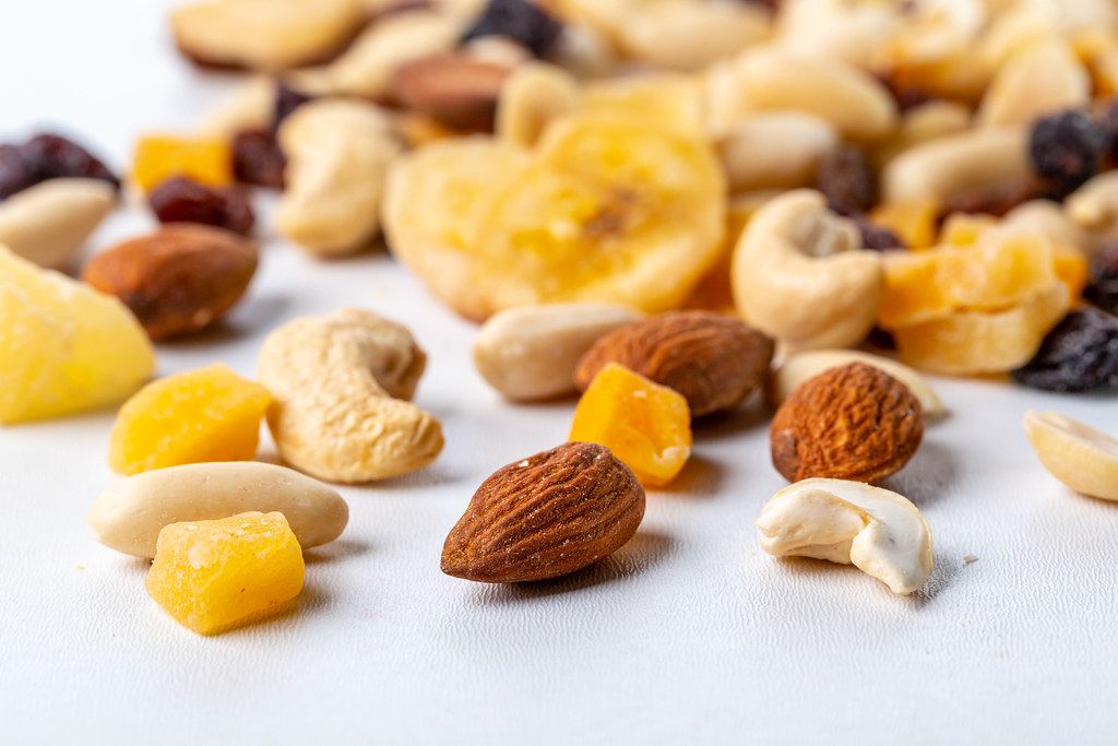 Dried fruits and different nuts on white background