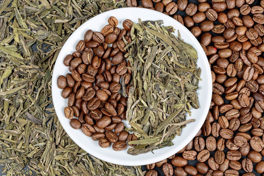 Dried green tea and coffee beans background