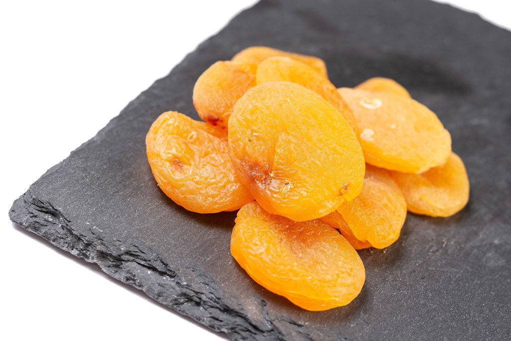 Dried Peaches on the black stone tray