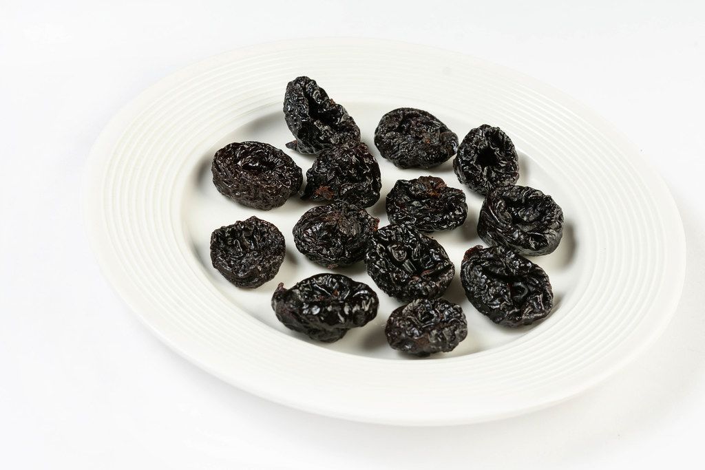 Dried Plums above white background