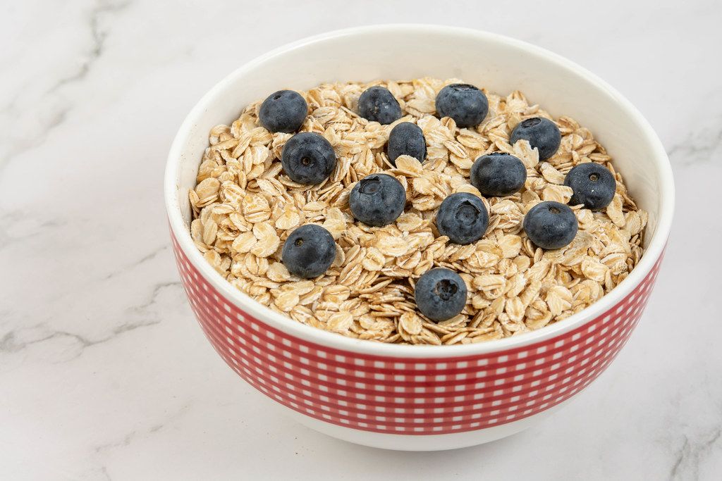 Dry and fresh Oatmeal with Blueberries in the bowl