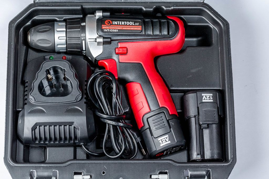 Electric screwdriver with battery in black tool case