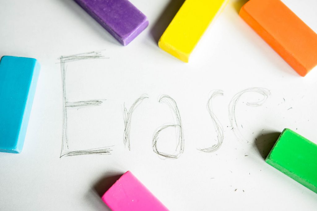 ERASE word being erased from a white paper