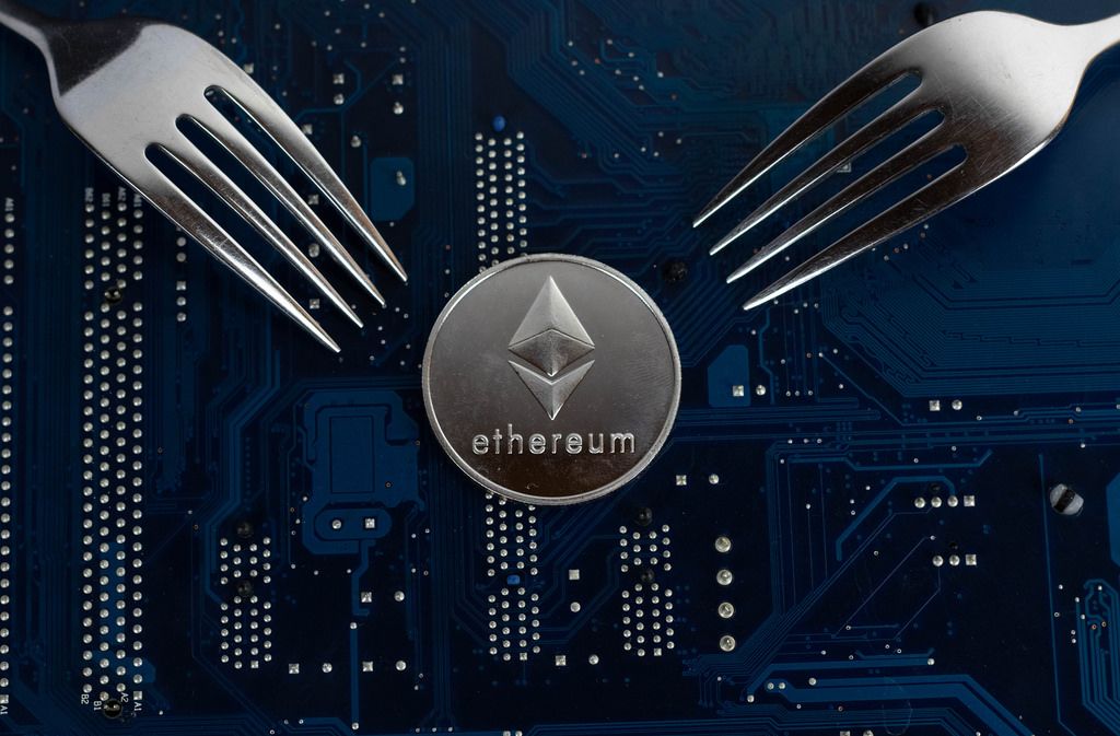 Ethereum coin with forks on motherboard