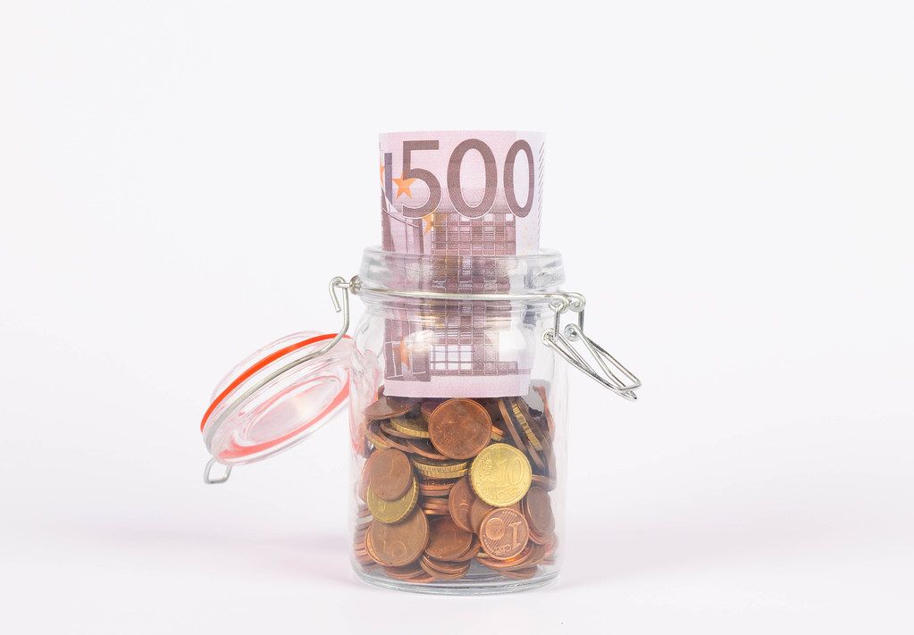Euro banknotes in a glass jar
