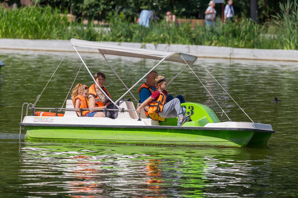 Familie in einem Tretboot genießt das schöne Wetter im Gorki-Park