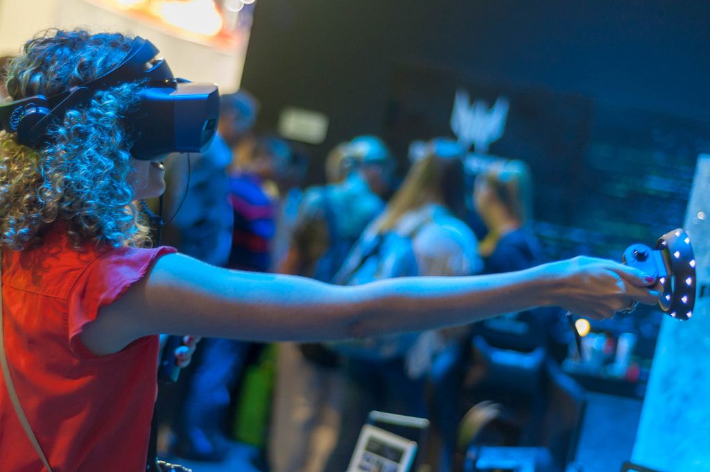 Female fair visitor using Microsoft Mixed Reality headset and controller