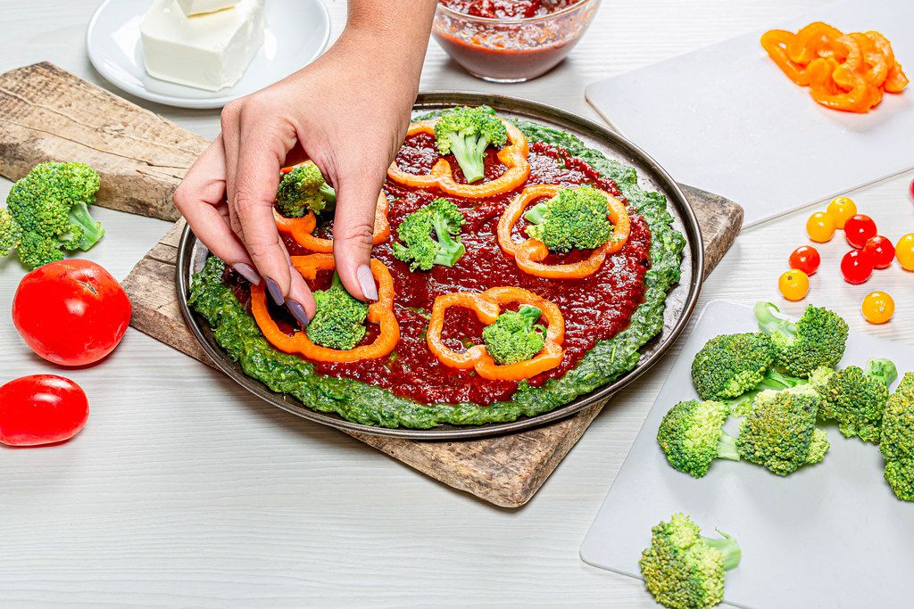 Female Hands Put Pieces Of Broccoli On Pizza The Concept Of Healthy Food Creative Commons Bilder