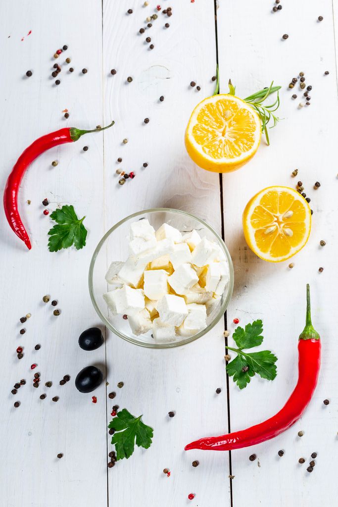 Feta cheese, chili, olives, parsley and peppers on white wooden background (Flip 2019) (Flip 2019) Flip 2019