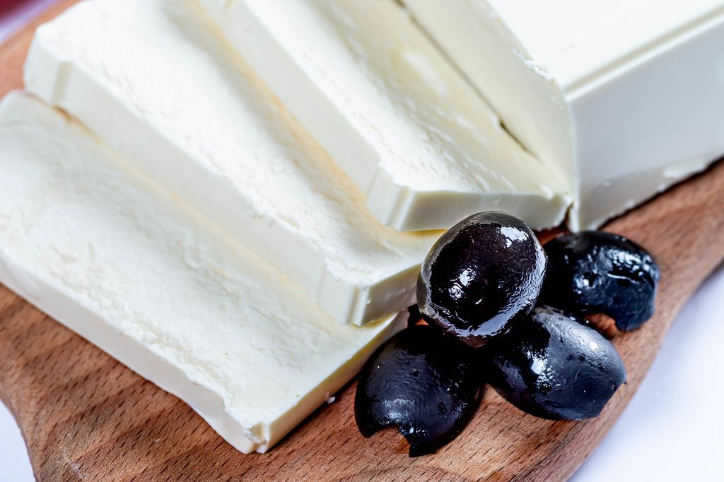 Feta cheese with olives on wooden board (Flip 2019) (Flip 2019) Flip 2019