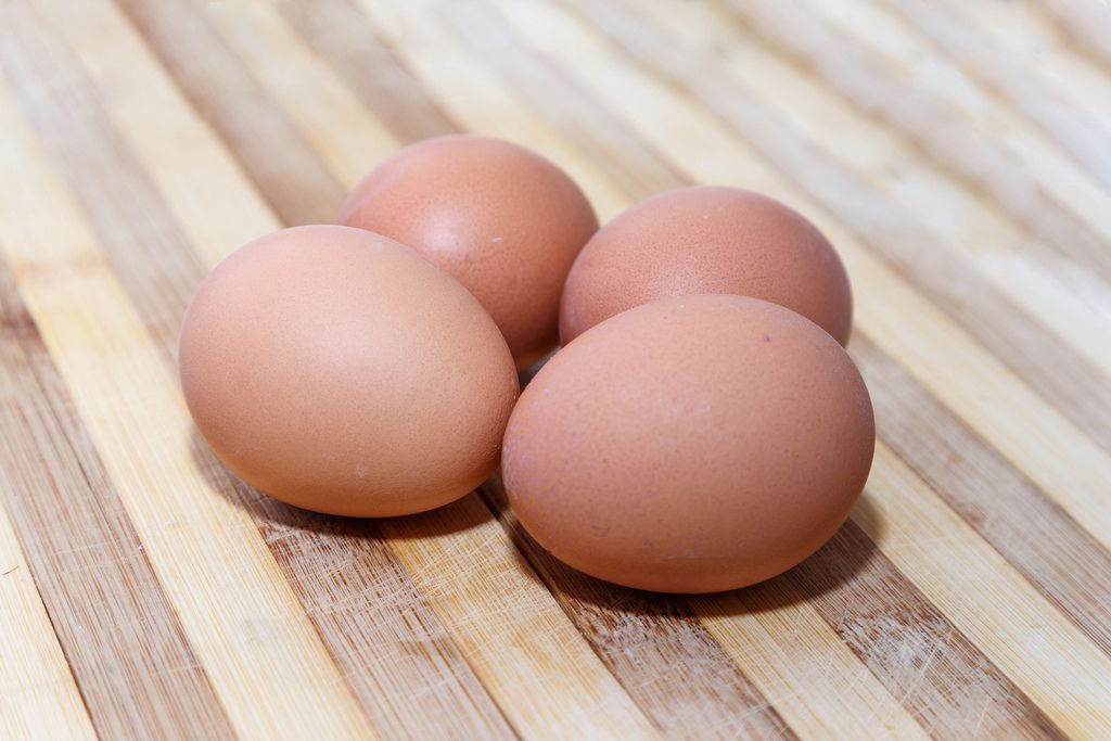 Few eggs on wooden background