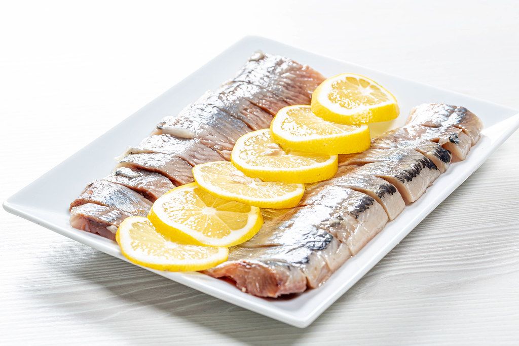 Fillet pieces salted herring with lemon