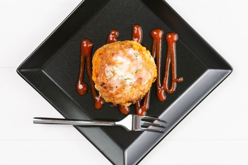Flat lay above Meatball with melting cheese on the white plate