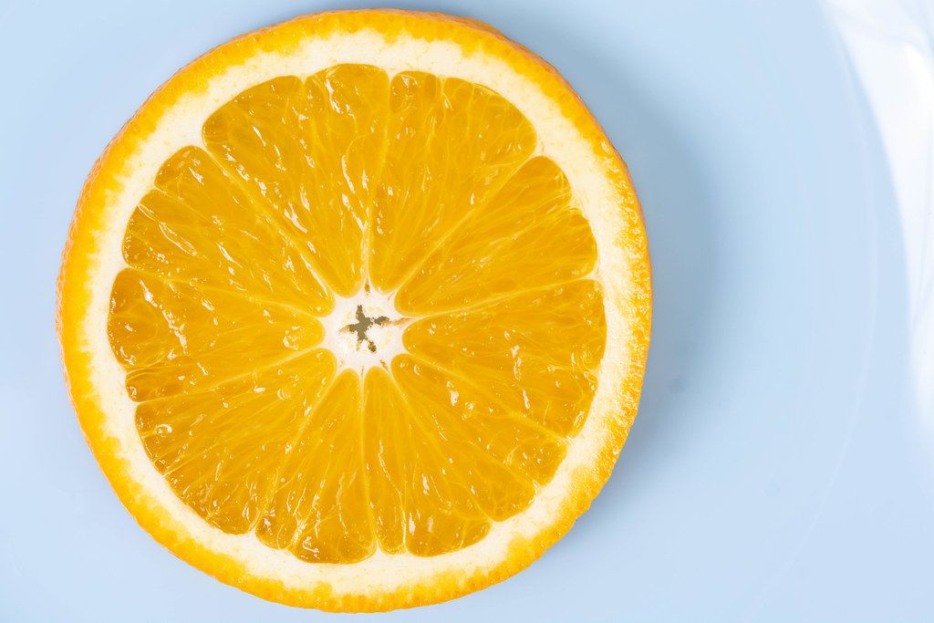 Flat lay above sliced Orange fruit on the blue plate (Flip 2019)