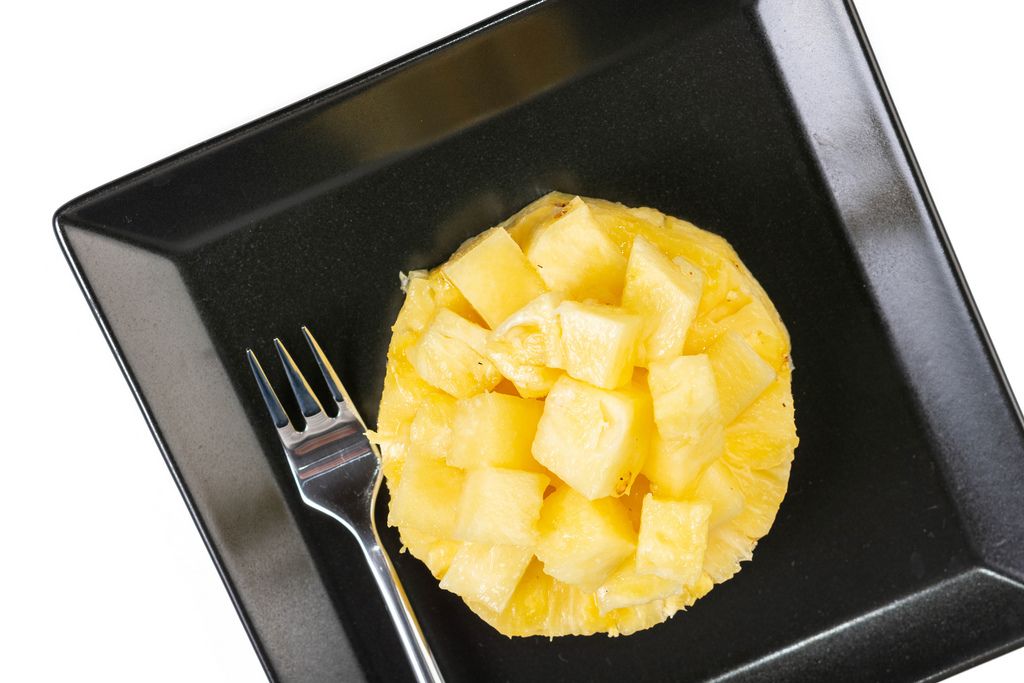 Flat lay above sliced Pineapple on the plate