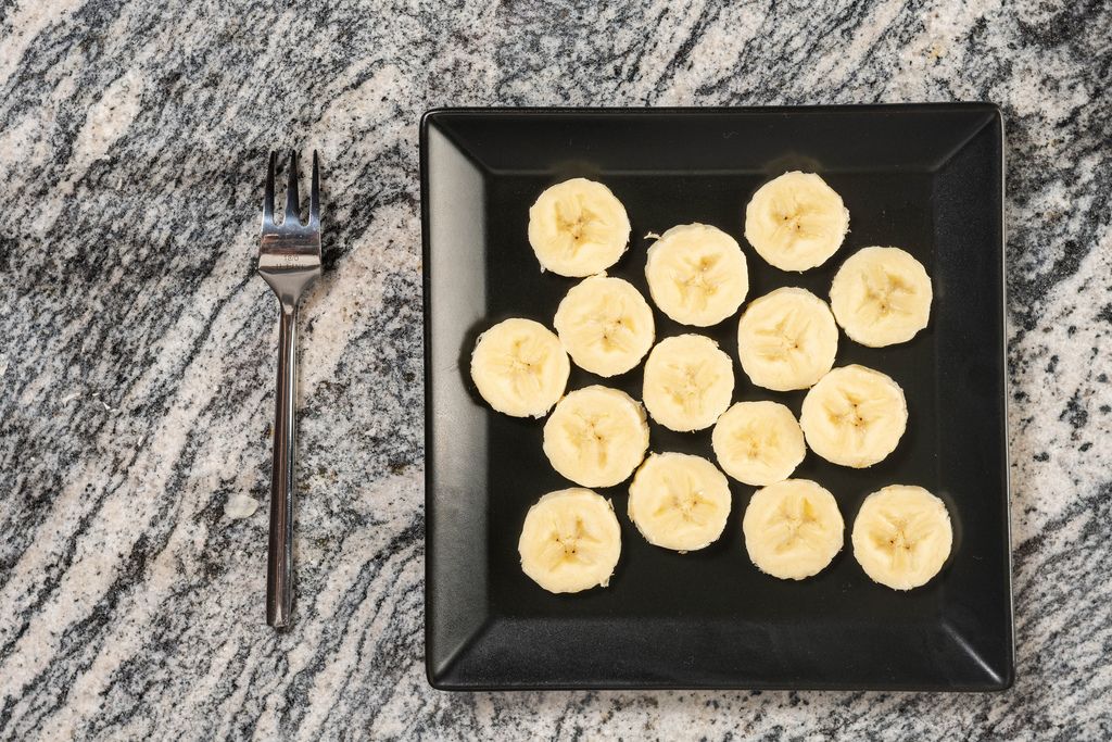 Flat lay above Square plate with Sliced Banana