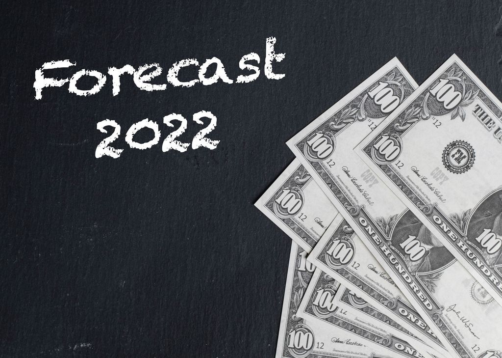 Forecast 2022 text with US dollar banknotes