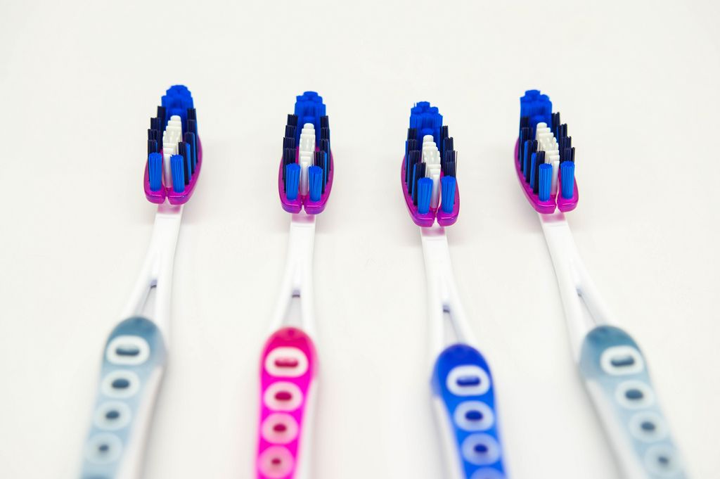 Four toothbrushes in a row