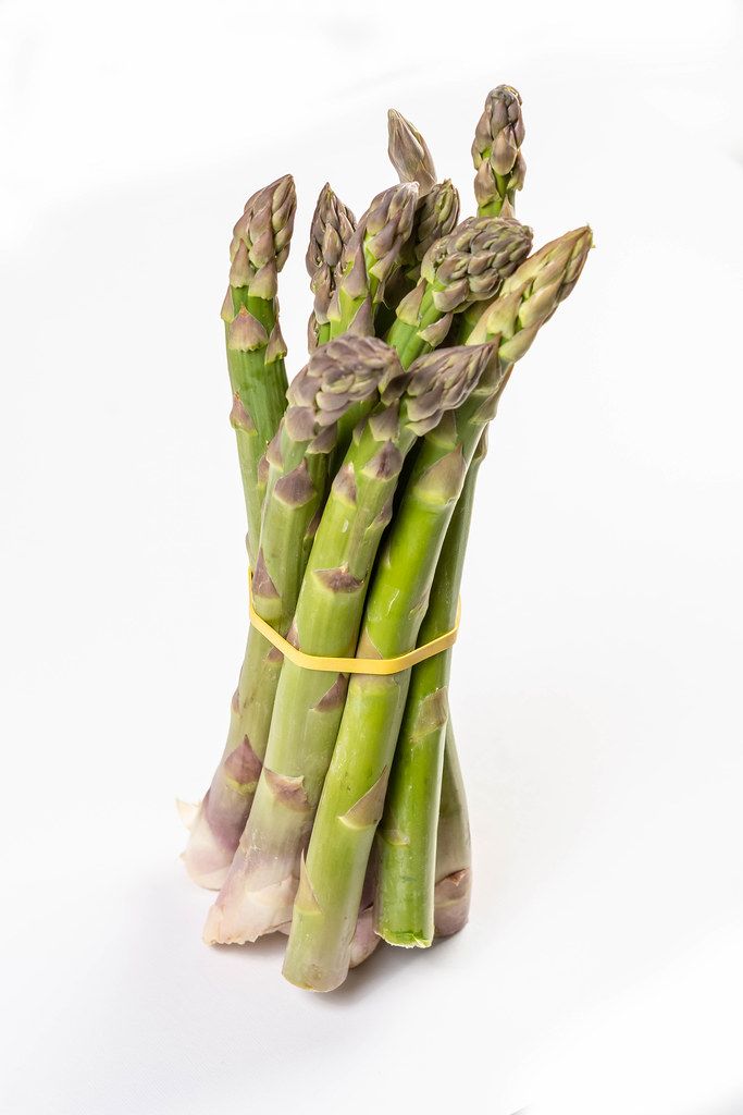 Fresh Asparagus above white background