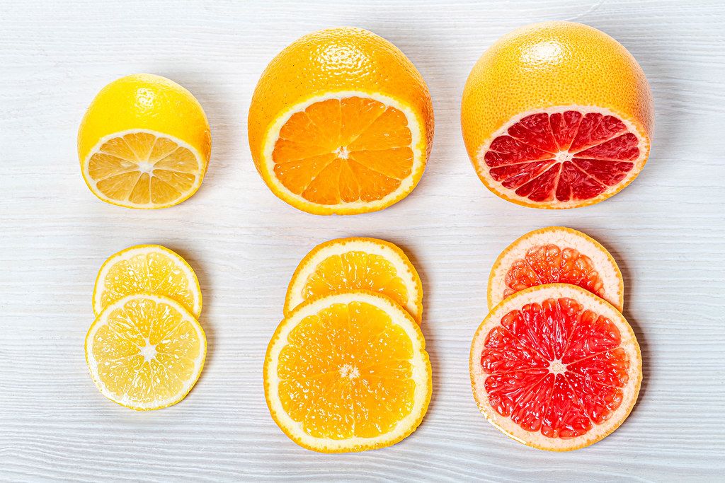 Fruit Background With Half A Grapefruit Orange Lemon And Mandarin On