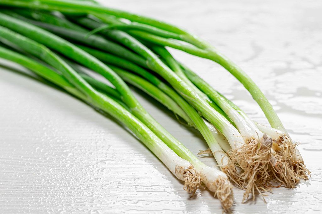 Fresh young onion white wooden background (Flip 2019)