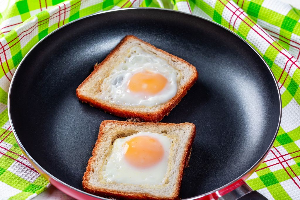 Fried eggs in toast bread in a frying pan