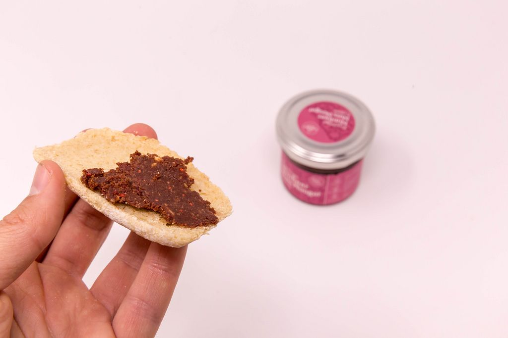 Fruity Raspberry - Nut-Nougat spread  on bread with jar in background