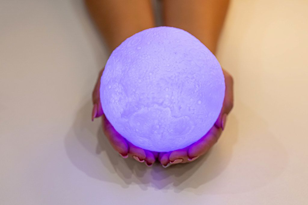 Full purple moon night light in the hands of a woman (Flip 2019)