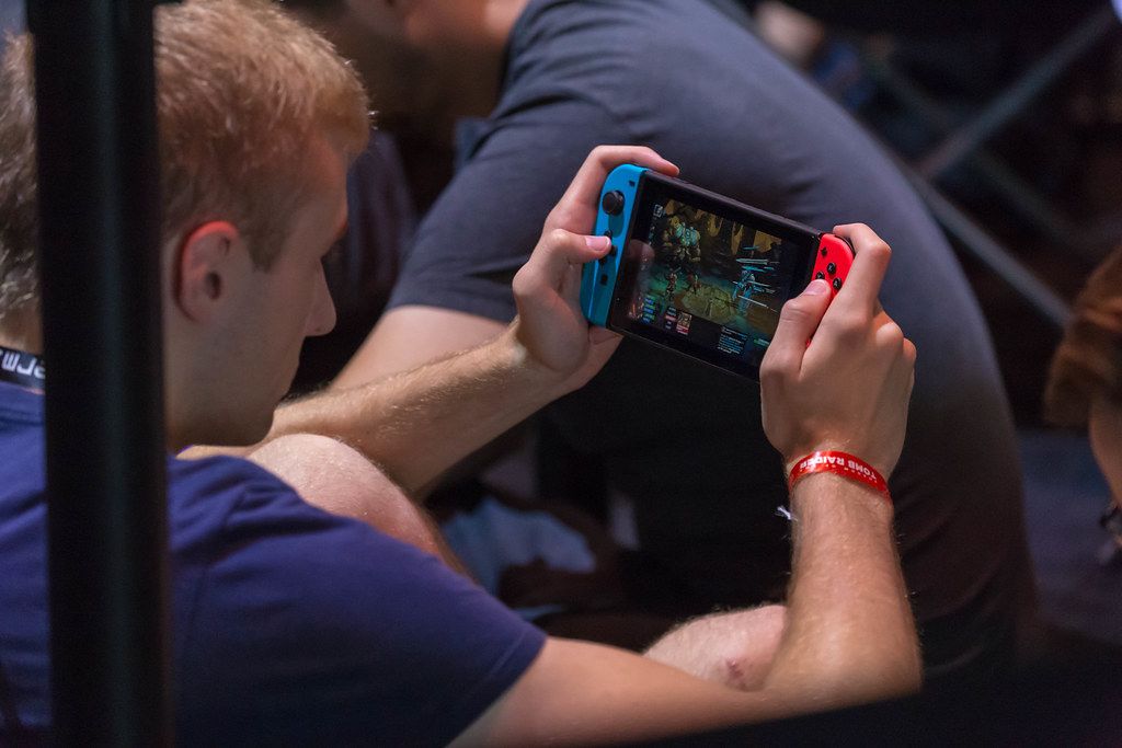 Gamescom 2018 visitor playing on his Nintendo Switch portable console