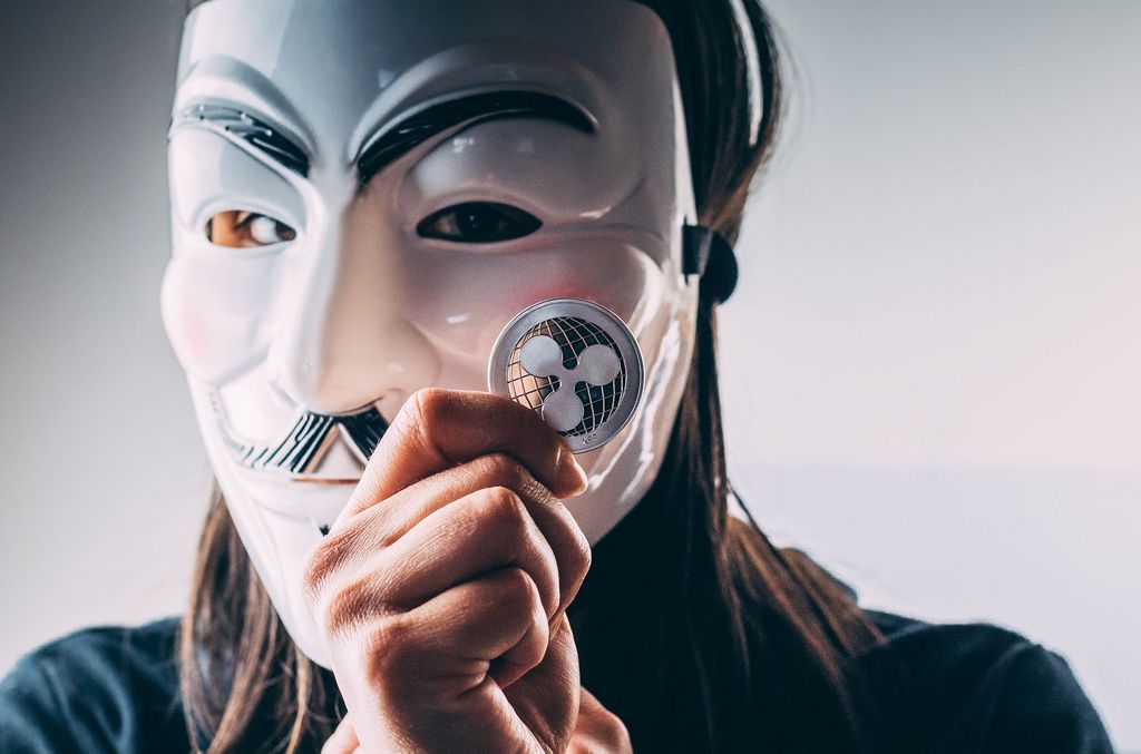 Girl with mask holding Ripple coin