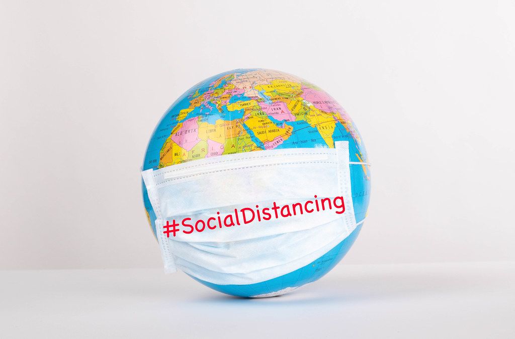 Globe with medical mask on white background with #SocialDistancing text