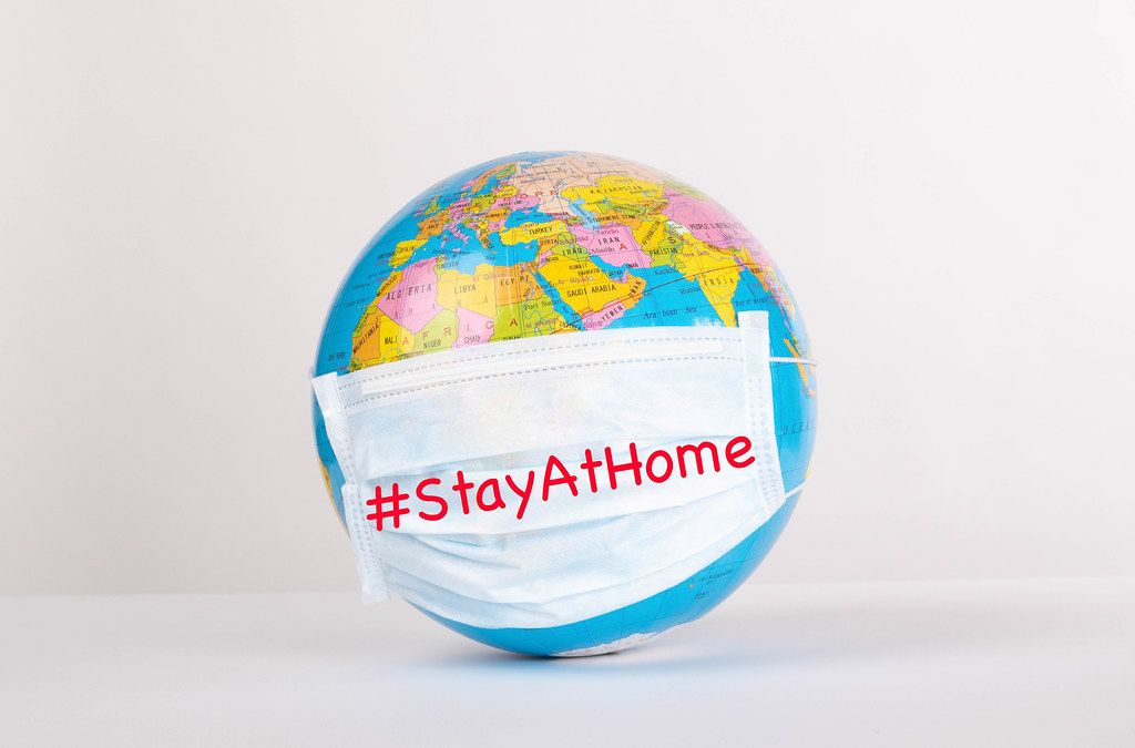Globe with medical mask on white background with #StayAtHome text