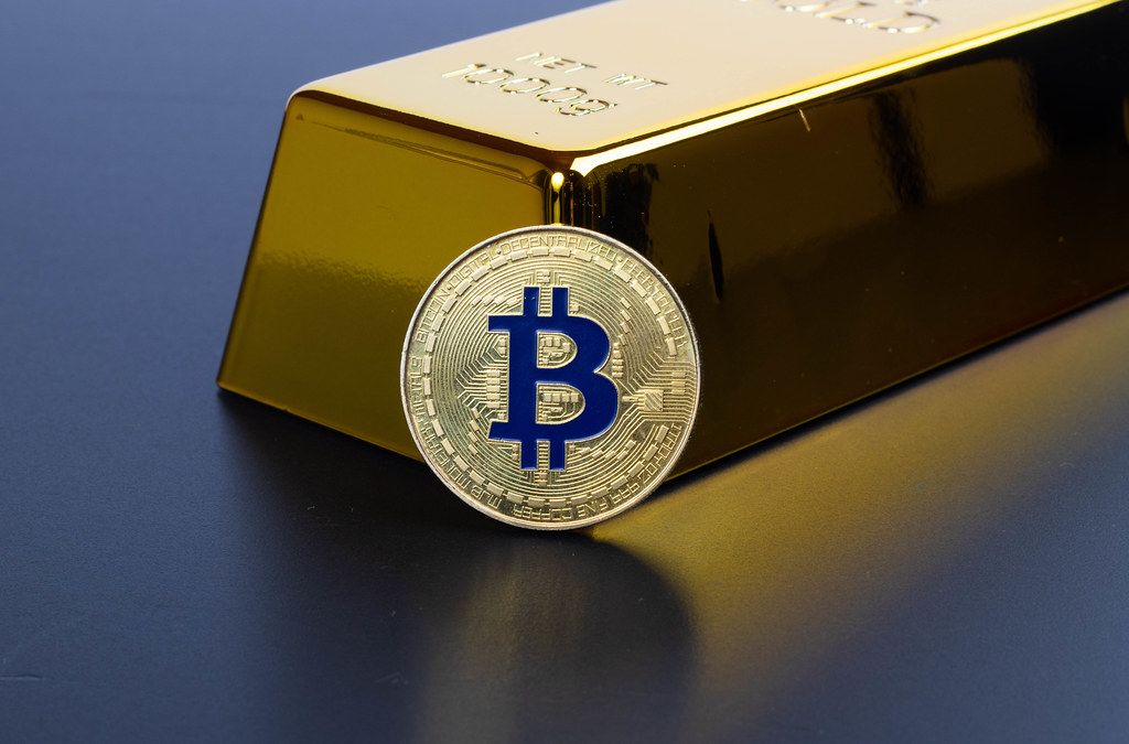 Gold bar with golden Bitcoin on a black background