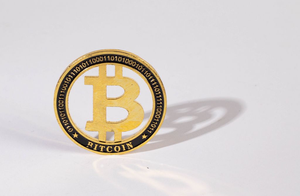 Golden Bitcoin isolated on a white background