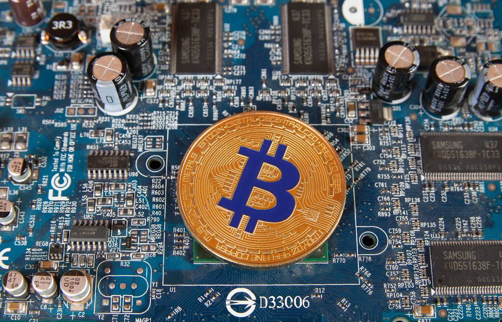 Golden Bitcoin on a computer mother board