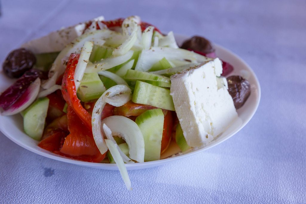 Greek salad with peppers, cucumbers, onions, olives and feta cheese