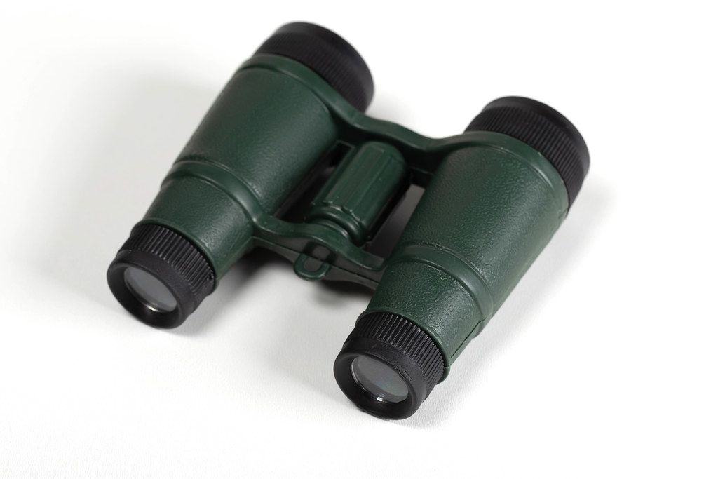 Green plastic binoculars on a white background