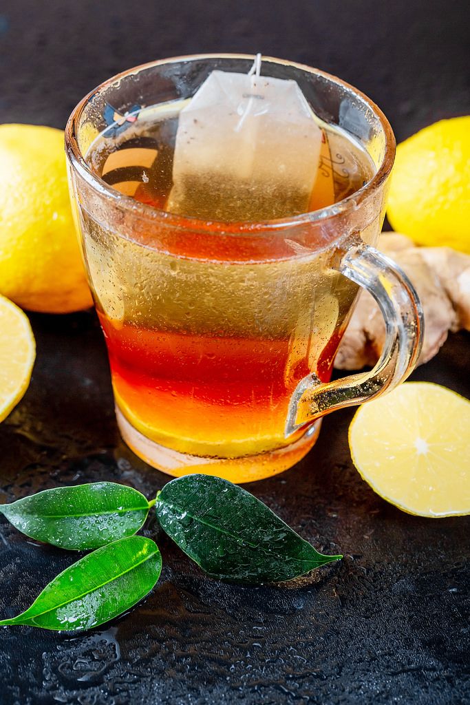 Green tea with lemon and fresh tea leaves