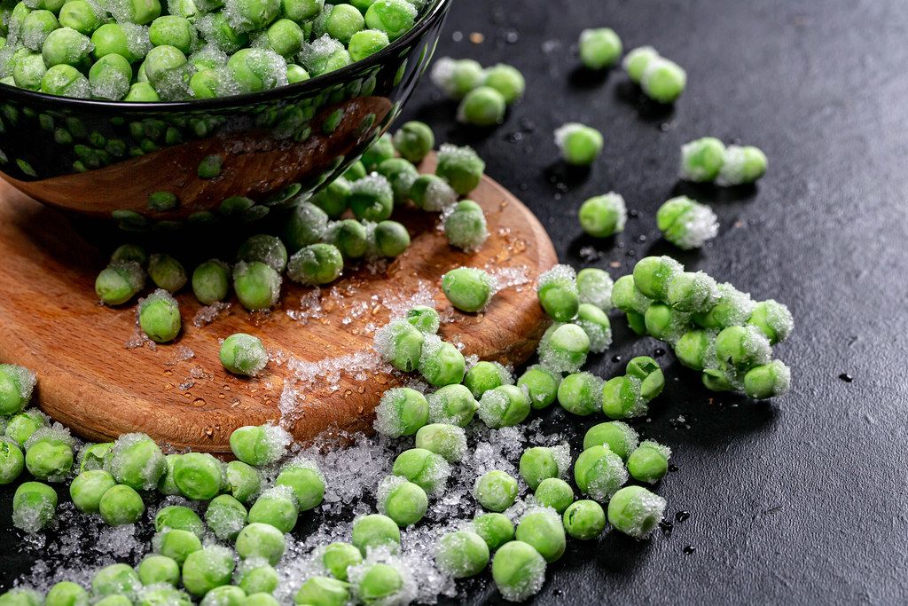 Green young frozen peas with ice closeup (Flip 2019)