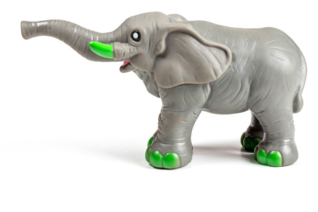 Grey elephant toy on a white background