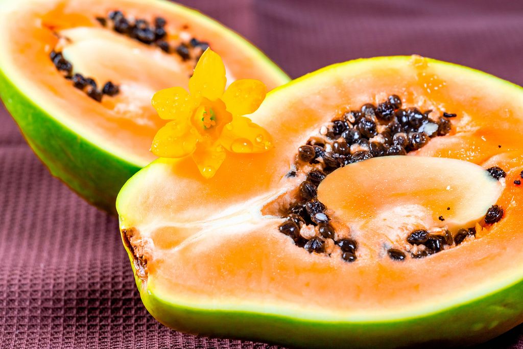 Halves of fresh papaya fruit with seeds