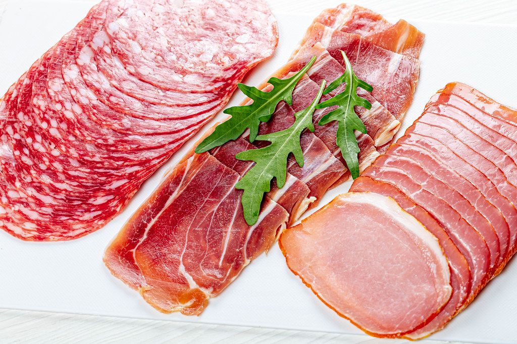 Ham, jamon and salami with fresh arugula leaves (Flip 2019)