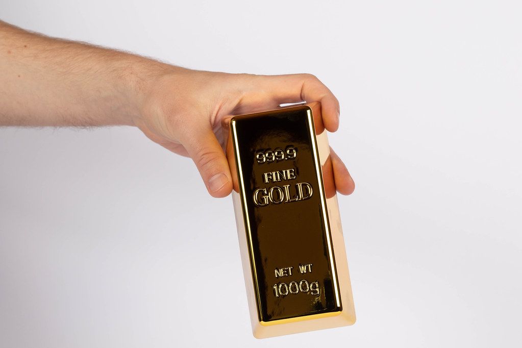 Hand with gold bar