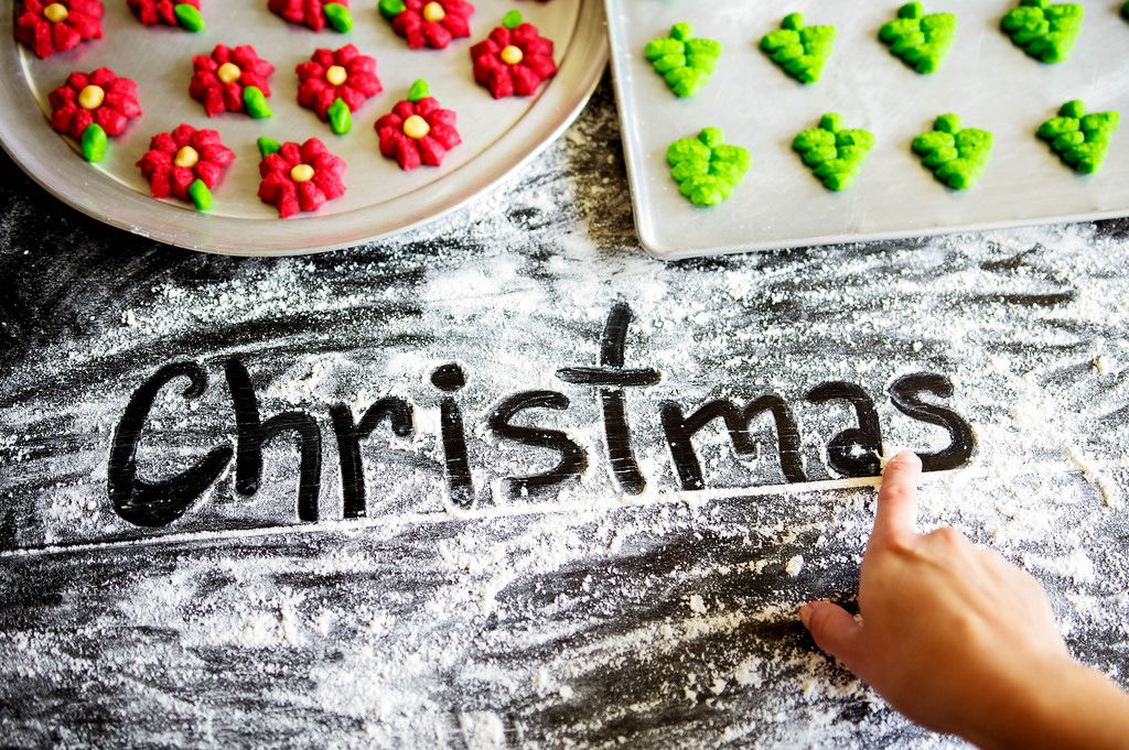 Hand writing CHRISTMAS on flour