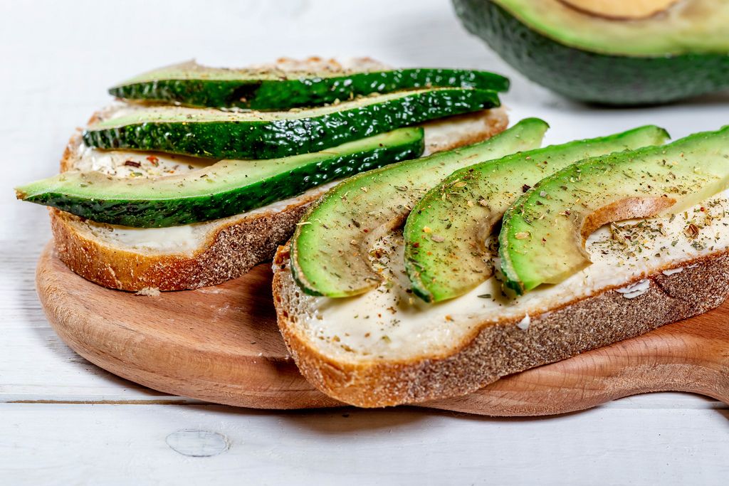 Healthy avocado sandwich with cheese and dark bread