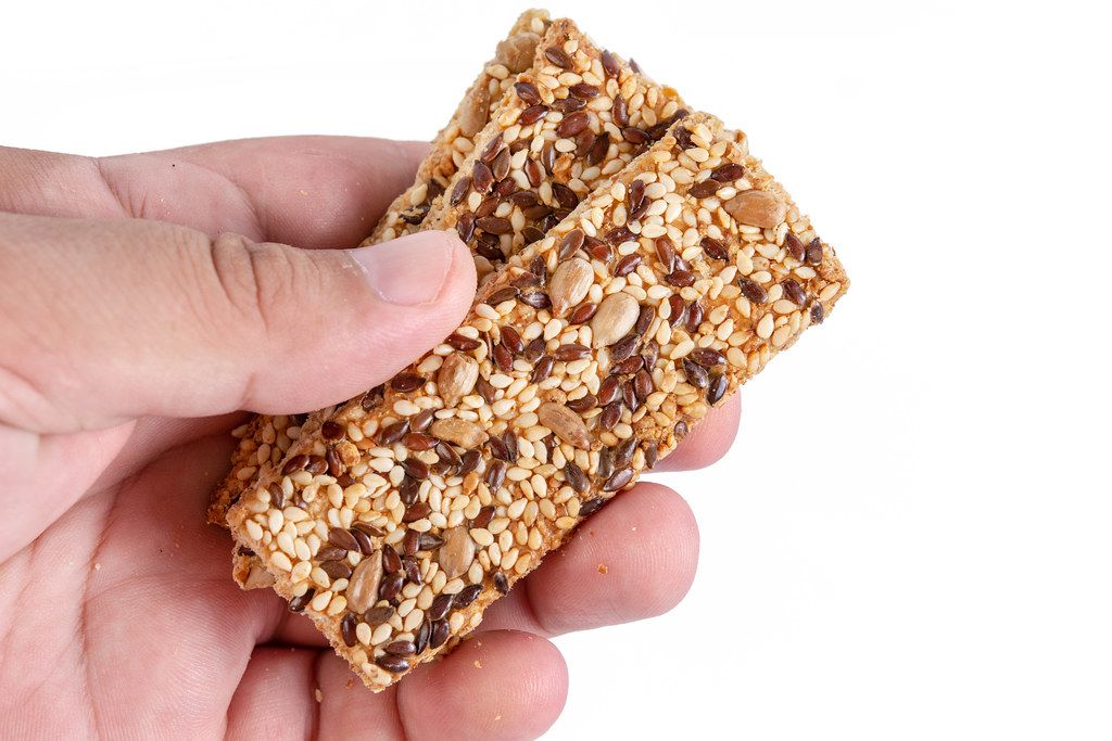 Healthy Bars with Sesame and Sunflower Seeds in the hand