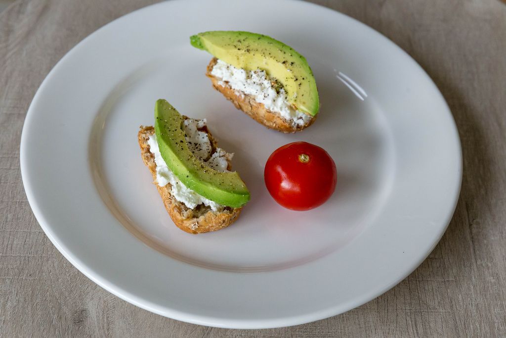 Healthy snack with wheat bread, tomato, avocado and cottage cheese